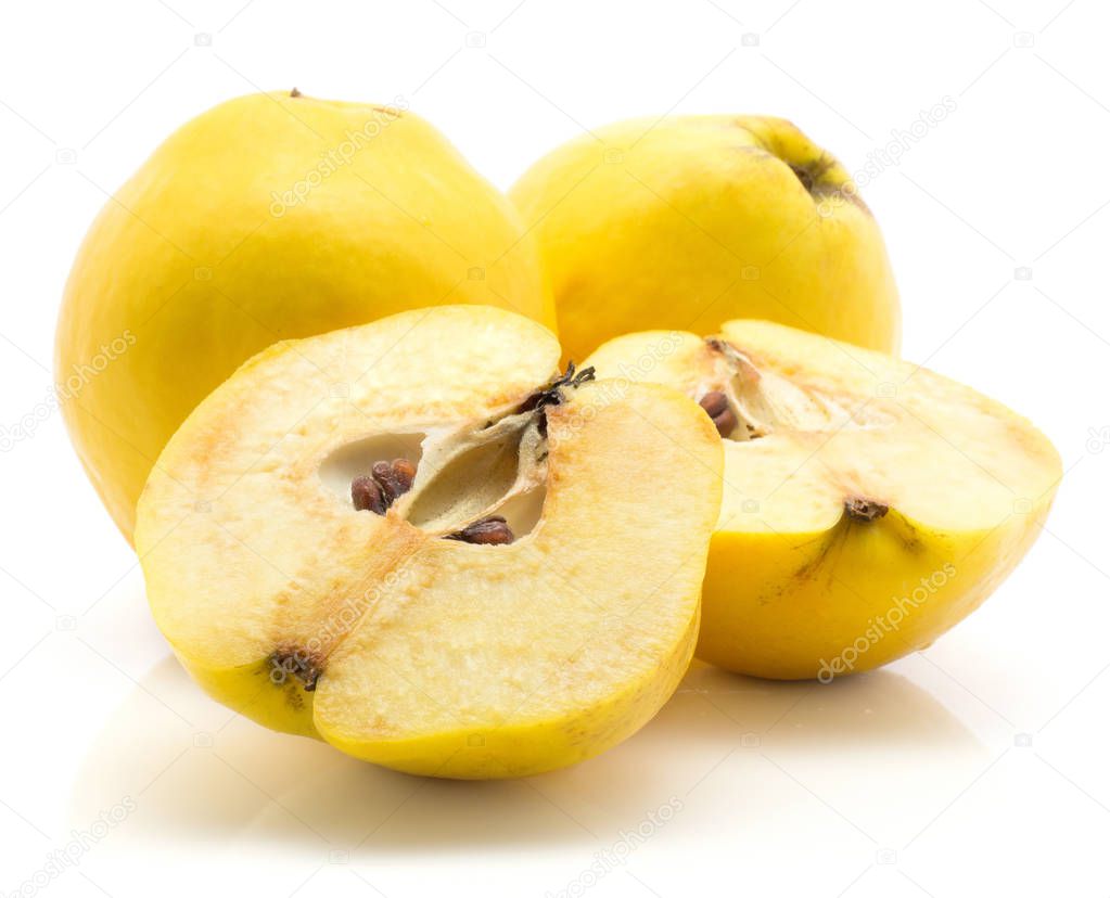Two yellow quinces with two halves isolated on white background raw ripe one cut in half with seeds inside