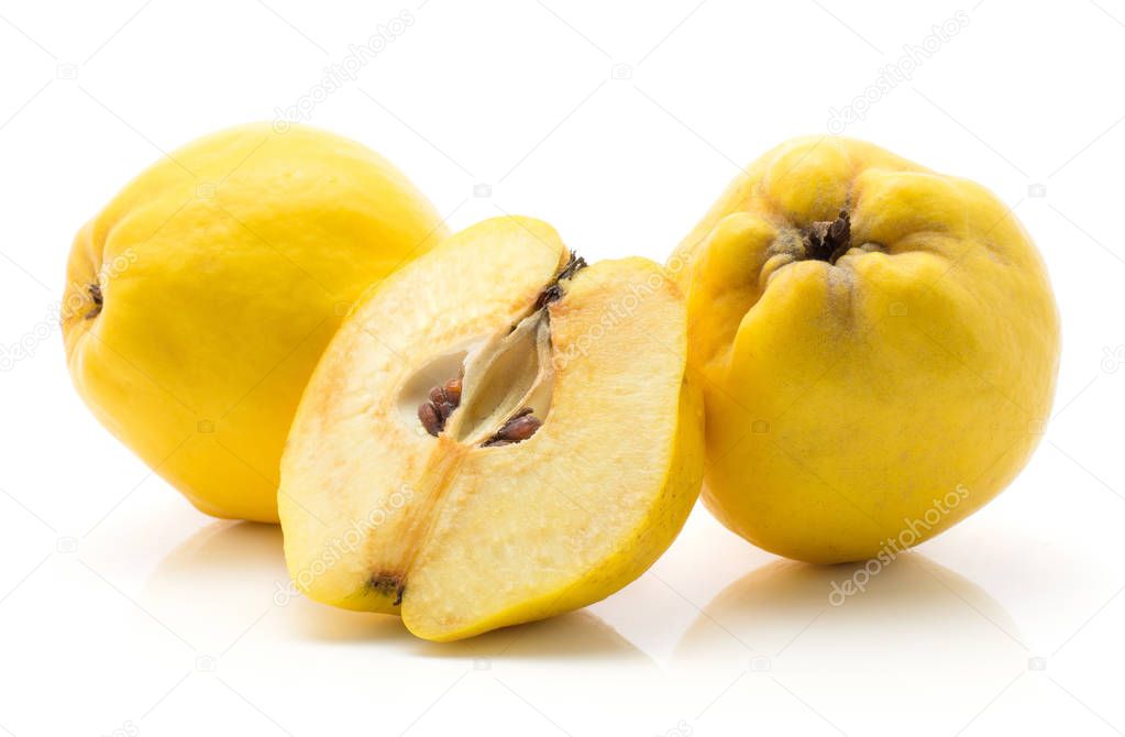 Two yellow quinces with one half isolated on white background raw ripe