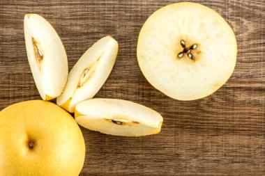 Çin altın armut üstten görünüm Nash'e çeşitli ahşap arka plan üzerinde bir tüm kesit yarısı izole ve üç dilim