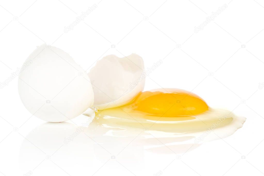 One cracked white chicken egg isolated on white background two pieces of shell and raw fresh yol
