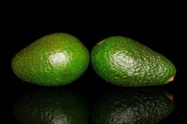 Frische grüne Avocado isoliert auf schwarzem Glas — Stockfoto