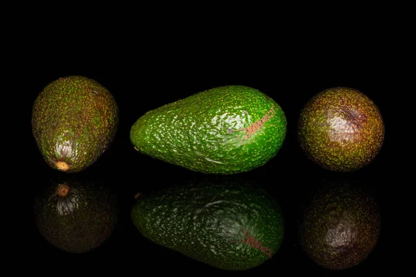 Fresh green avocado isolated on black glass — Stock Photo, Image