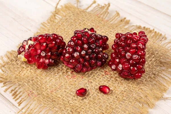 Fresh red pomergranate on grey wood — Stock Photo, Image