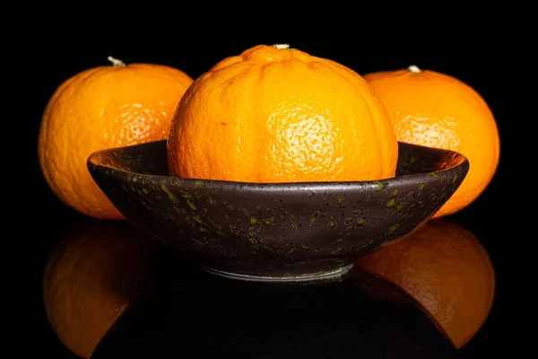 Fresh orange mandarine isolated on black glass — Stock Photo, Image