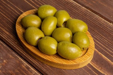 Kahverengi tahtada yeşil zeytin meyvesi