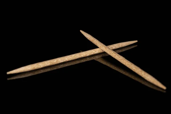 Wooden brown toothpick isolated on black glass — Stock Photo, Image