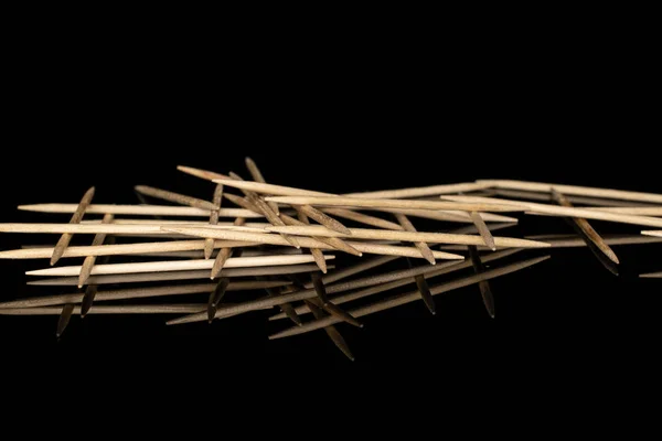 Wooden brown toothpick isolated on black glass — Stock Photo, Image