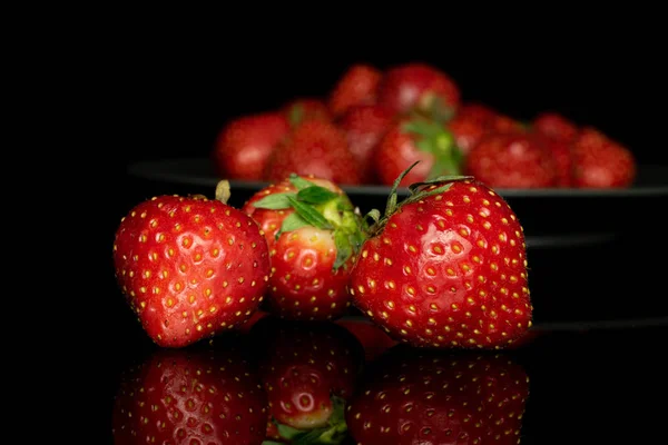 Fresh red strawberry isolated on black glass — Stock Photo, Image