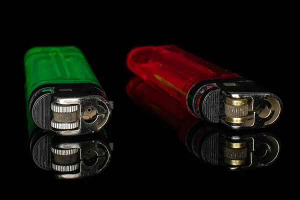 Plastic lighter isolated on black glass — Stock Photo, Image