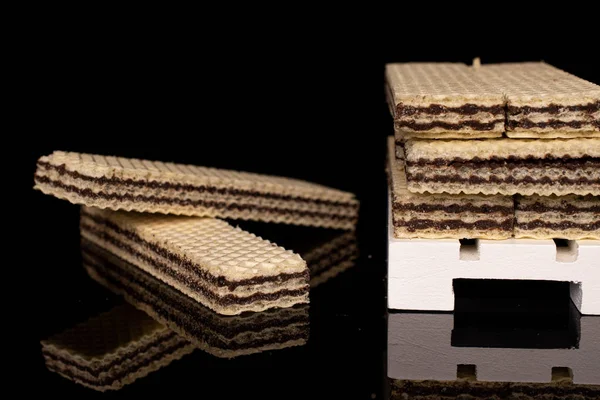 Chocolate biscuit wafer isolated on black glass