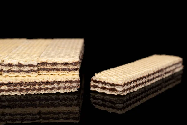 Chocolate biscuit wafer isolated on black glass