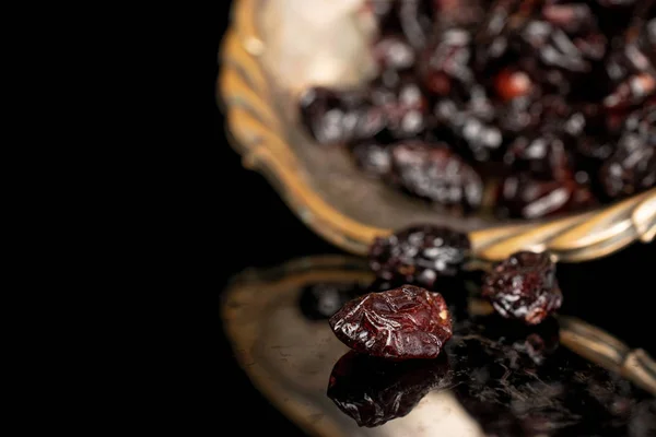 Dried cowberry isolated on black glass — Stock Photo, Image