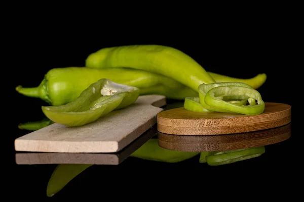 Hot green pepper isolated on black glass — Stock Photo, Image