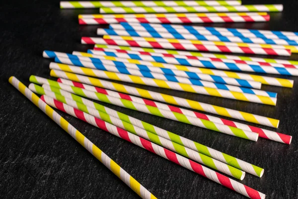 Colorful paper straw on grey stone — Stock Photo, Image