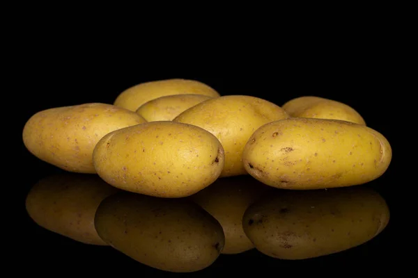 Yellow pale potato isolated on black glass — Stock Photo, Image