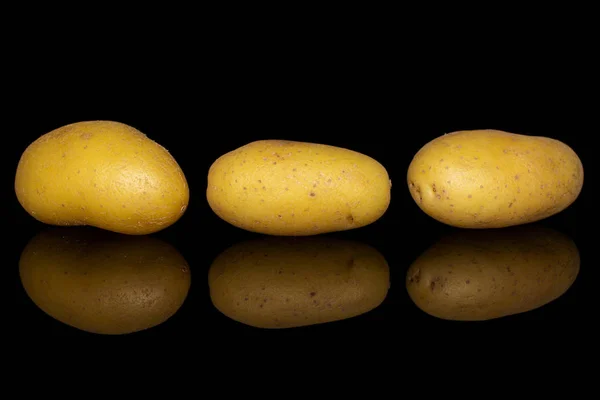 Yellow pale potato isolated on black glass — Stock Photo, Image