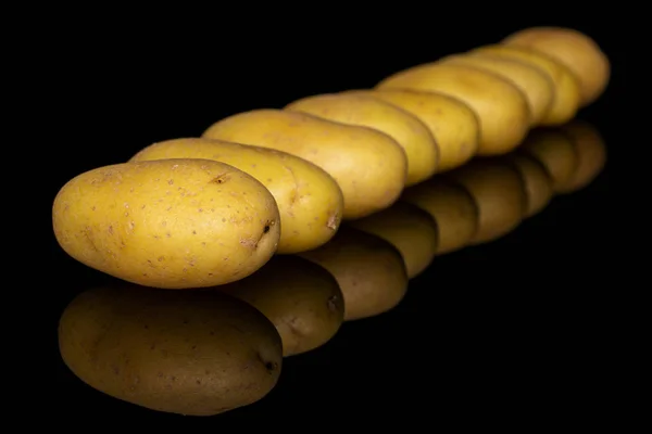 Yellow pale potato isolated on black glass — Stock Photo, Image