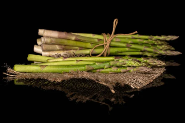 Healthy green asparagus isolated on black glass — Stock Photo, Image