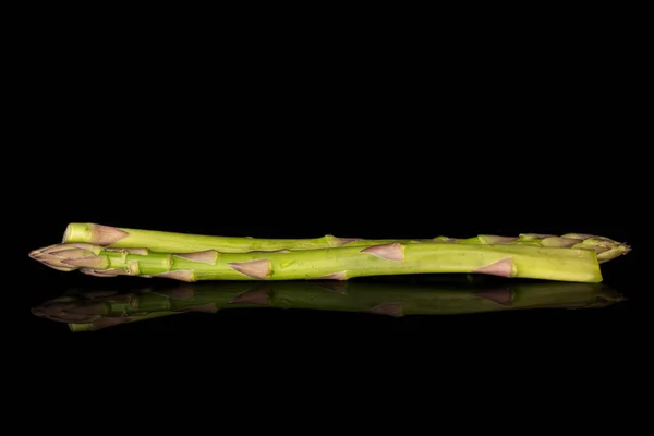 Healthy green asparagus isolated on black glass — Stockfoto