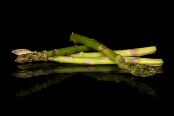 Healthy green asparagus isolated on black glass — Stock Photo, Image