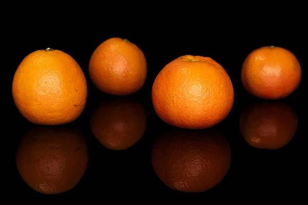 Fresh orange mandarin isolated on black glass — Stock Photo, Image