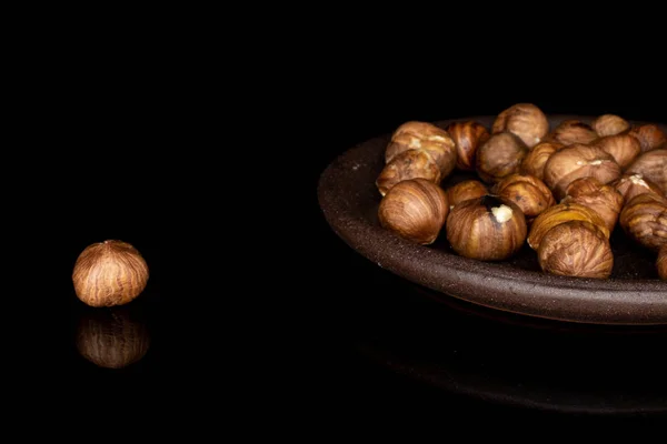 Tasty brown hazelnut isolated on black glass — Stock Photo, Image