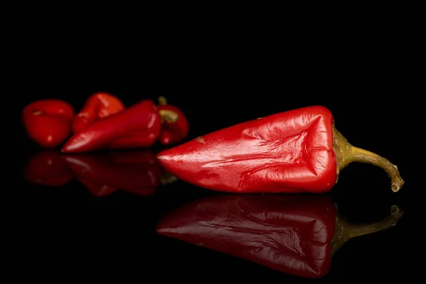 Hot pickled pepper isolated on black glass — Stock Photo, Image