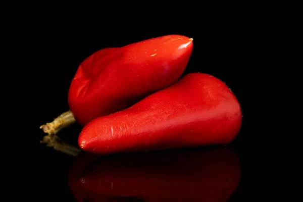 Hot pickled pepper isolated on black glass — Stock Photo, Image