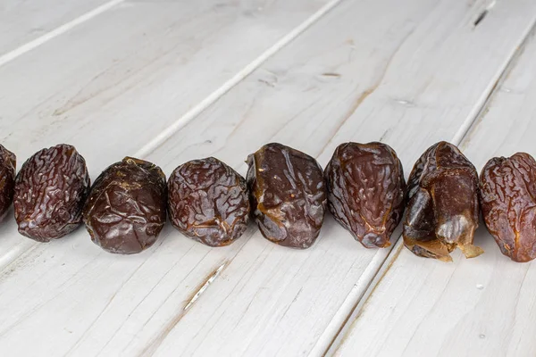 Dried date fruit on grey wood — Stock Photo, Image