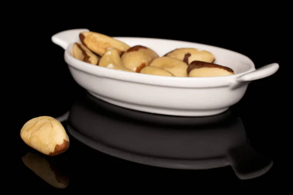 Brown brazil nut isolated on black glass — Stock Photo, Image