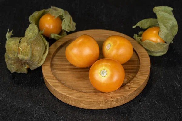 Fresh orange physalis on grey stone — Stock Photo, Image