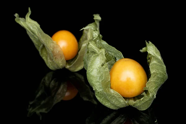 Fresh orange physalis isolated on black glass — Stock Photo, Image