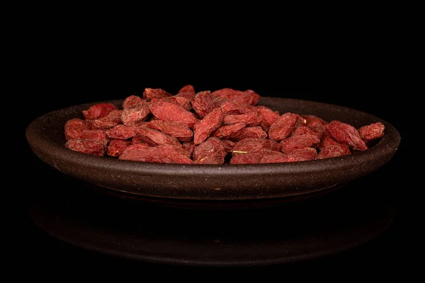 Red dried goji isolated on black glass — Stock Photo, Image