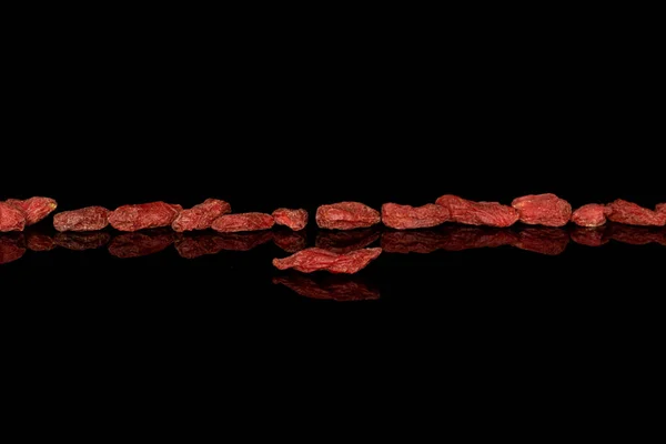 Red dried goji isolated on black glass — 스톡 사진