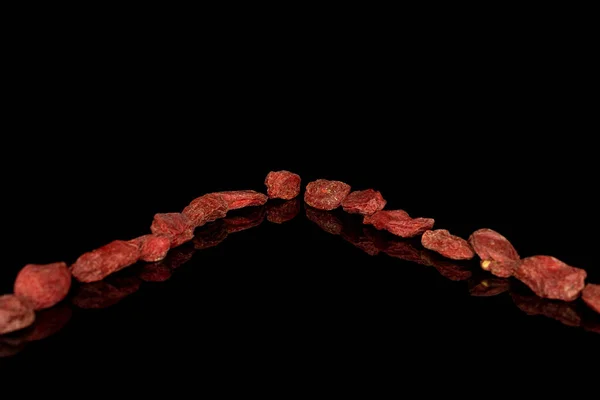 Red dried goji isolated on black glass — 스톡 사진