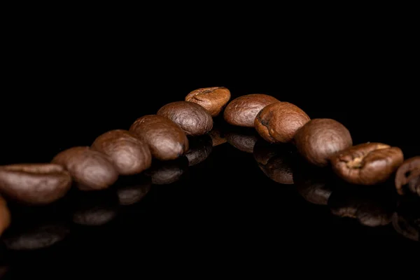 Fresh coffee bean isolated on black glass — 스톡 사진