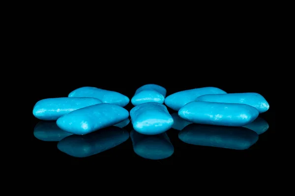 Blue chewing gum isolated on black glass — Stock Photo, Image