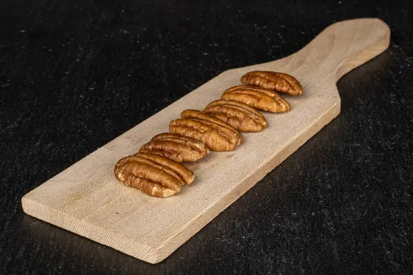 Brown pecan nut on grey stone — Stock Photo, Image