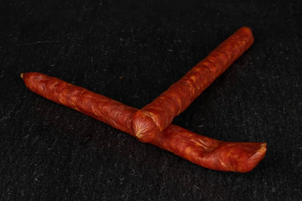 Smoked spicy sausage on grey stone — 스톡 사진