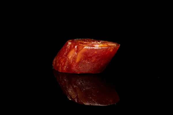 Smoked spicy sausage isolated on black glass — 스톡 사진