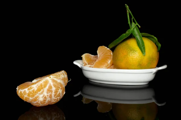 Fresh orange mandarin isolated on black glass — Stock Photo, Image