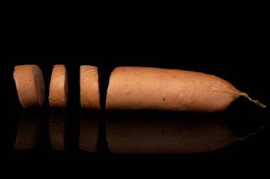 German pork sausage isolated on black glass