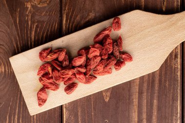 Red dried goji on brown wood