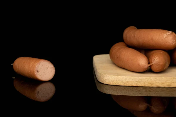 German pork sausage isolated on black glass — 图库照片