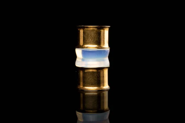Stylish ear plug isolated on black glass — 스톡 사진