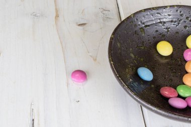 Sweet colourful candy on grey wood