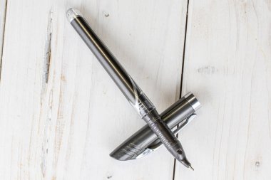 Ballpoint writing pen on grey wood