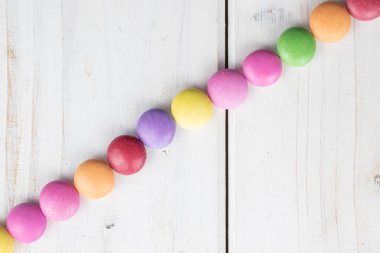 Sweet colourful candy on grey wood
