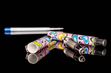 Ballpoint writing pen isolated on black glass
