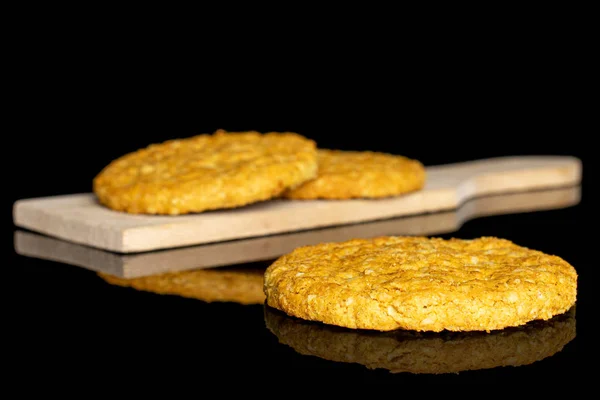 Sweet oat cookie isolated on black glass — Stock Photo, Image